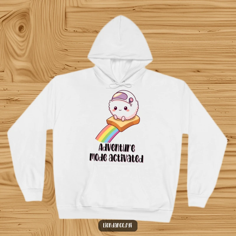 Funny hoodie depicting a fluffy creature in a tiny helmet sliding down a rainbow on a slice of toast.